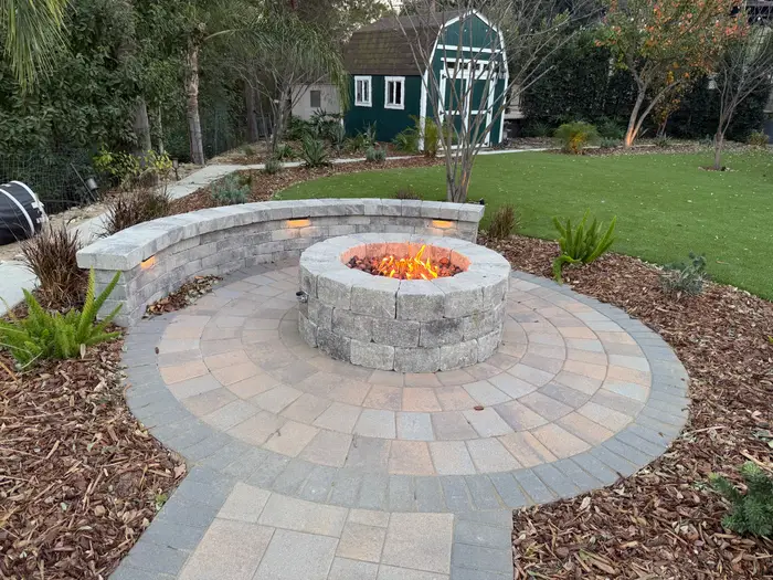Round fire pit on a circular paver pad with seat wall, La Habra